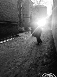 Rear view of woman walking on street