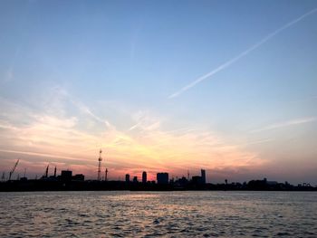 Silhouette buildings against sky during sunset