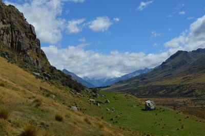 Scenic view of mountains against cloudy sky