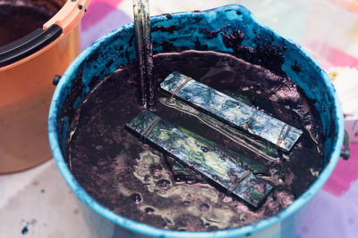 High angle view of paintbrushes in container