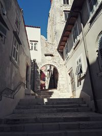 Low angle view of stairs along buildings