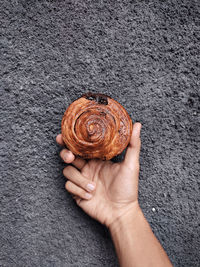 Cropped hand of person holding pumpkin