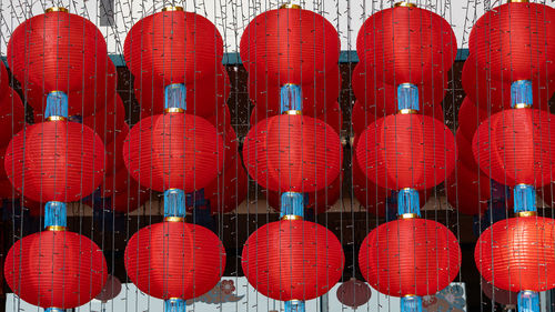 Full frame shot of red lanterns hanging in row