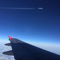 Cropped image of airplane flying in sky