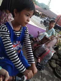 High angle view of siblings holding ice cream