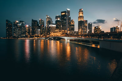 Illuminated buildings against sky at night