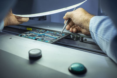 Midsection of man working on table