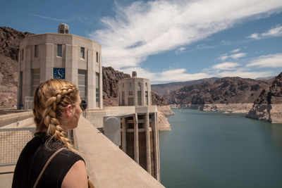 Woman by water against sky