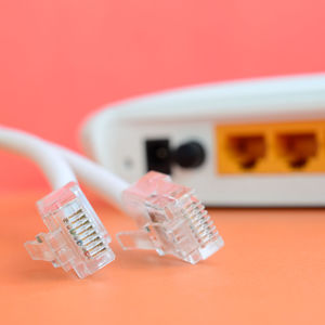 Close-up of router with cables on orange background