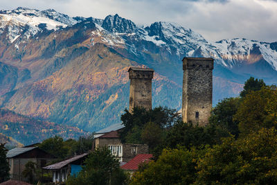 Scenic view of buildings and mountains against sky