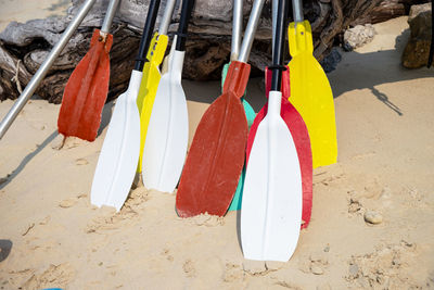 Close-up of multi colored paddles on beach