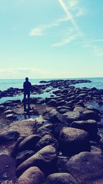 Man standing on beach against sky