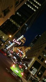 Illuminated city street at night