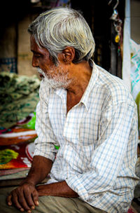 Portrait of man sitting outdoors