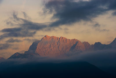 Scenic view of snowcapped mountains against sky during sunset