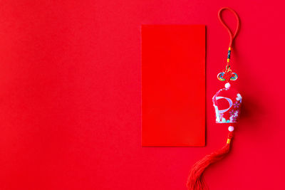 Close-up of red hanging against wall