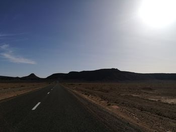 Road on desert against sky