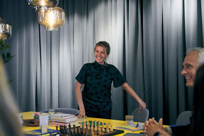 Cheerful businessman and businesswoman in board room at creative office