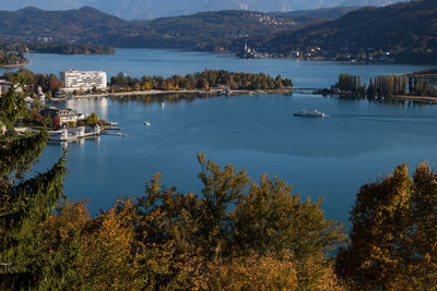 Scenic view of lake by trees and mountains