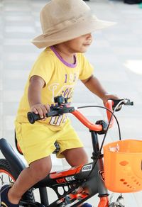 Boy riding bicycle on footpath