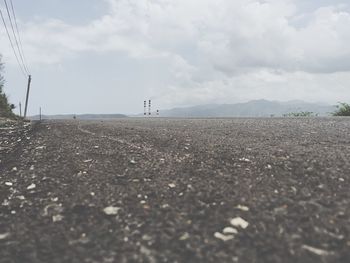 Surface level of landscape against cloudy sky