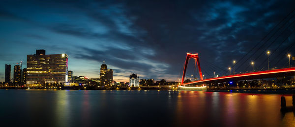 View of bridge over river at night