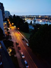 High angle view of city street and buildings at dusk