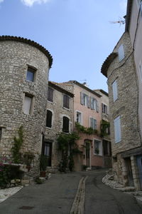 Street amidst buildings against sky