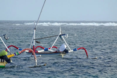 Nautical vessel in sea against sky