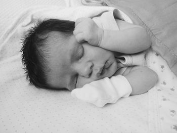 Close-up of baby sleeping on bed