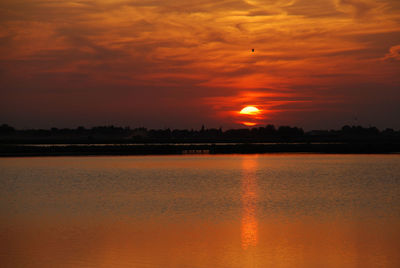 Scenic view of lake at sunset