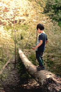 Side view of young man in forest