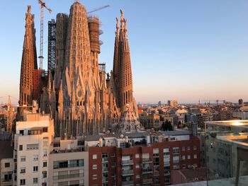 Panoramic view of buildings in city against clear sky
