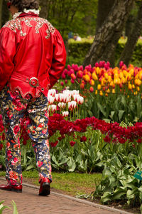 Rear view of a person standing by plants