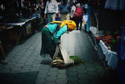 Rear view of people walking on street