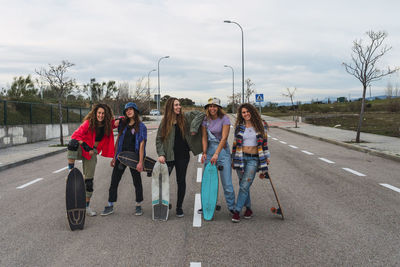 People on road against sky in city