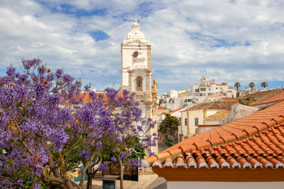 View of buildings against cloudy sky