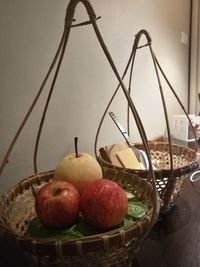 Close-up of apples in basket on table