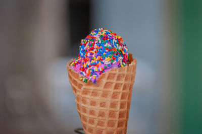 Close-up of ice cream cone with colorful sprinkles