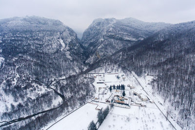 High angle view of ski lift against snowcapped mountains