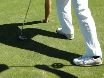 Low section of man standing on golf course