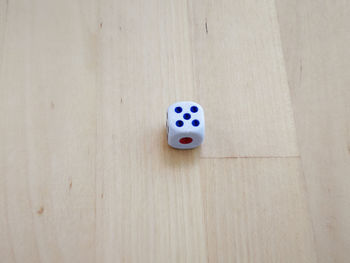 High angle view of dice on hardwood floor at home