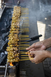 Cropped hand of person preparing food