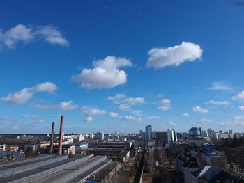 High angle view of buildings against cloudy sky