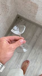 High angle view of hand holding wine glass