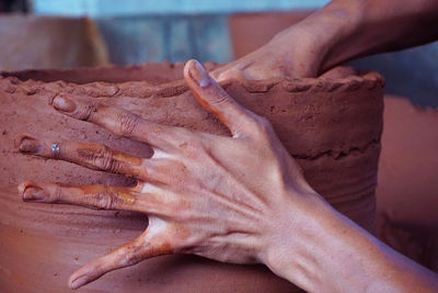 Close-up of person making pottery