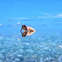 Young woman swimming in sea