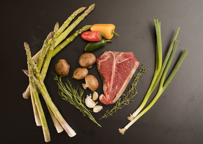 High angle view of vegetables on table against black background