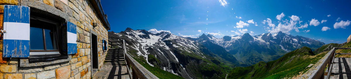 Road leading towards mountains against blue sky