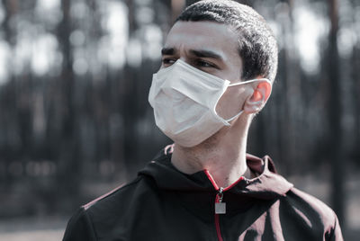 Close-up of man wearing mask looking away